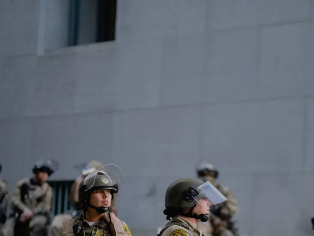 The image shows a group of police officers standing next to each other in front of a building. They...