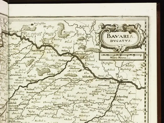 The image shows an open book with a map of Bavaria on it. The map is detailed and shows the various...