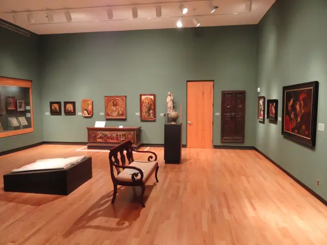 The image shows a room filled with lots of paintings on the walls, a bench, a table, a statue on a...