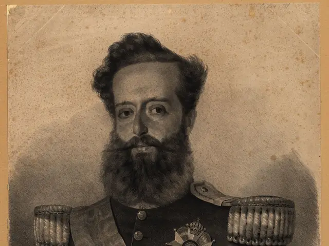 The image shows a black and white photo of a man with a beard wearing a military uniform. He has a...