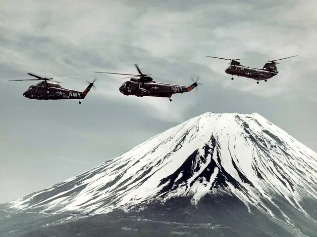 The image shows three military helicopters flying in formation over a snow-covered mountain, with a...