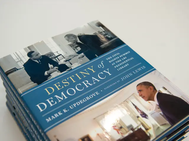 The image shows a stack of books sitting on top of each other on a white surface. The books have...