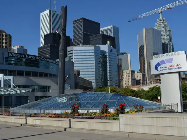 The image shows a bustling cityscape of Toronto, Ontario, Canada, with tall skyscrapers in the...