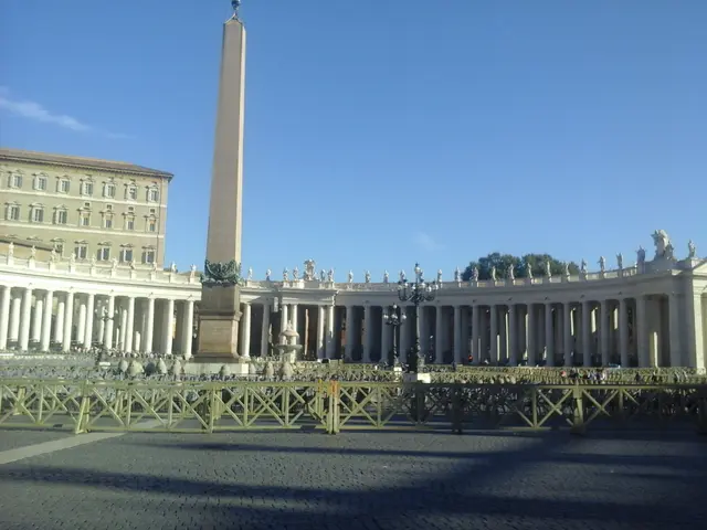 The image shows St. Peter's Square in Vatican City, Rome, Italy. It features a large building with...