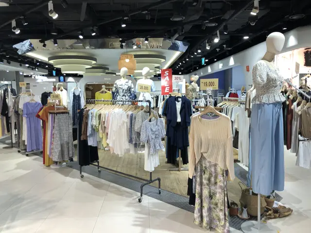 The image shows a clothing store filled with lots of clothes on display, with mannequins wearing...