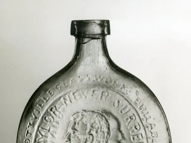 The image shows a glass bottle with a picture of a man on it. The bottle is made of glass and has...