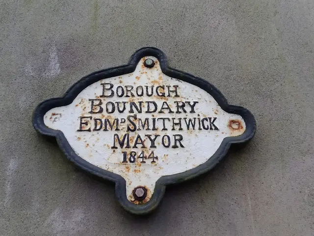 The image shows a plaque on the side of a building that reads "Borough Boundary Edm Smithwick...