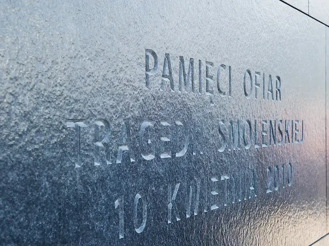 The image shows a close up of a wall with a plaque on it. The plaque is made of metal and has text...