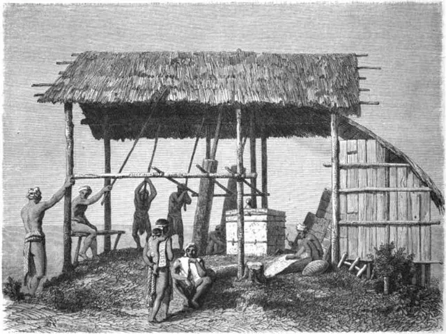 The image shows a black and white drawing of a group of people standing in front of a hut with a...