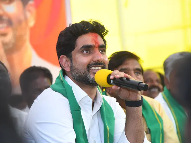 The image shows Jagan Mohan Reddy, wearing a white shirt and green scarf, holding a microphone and...