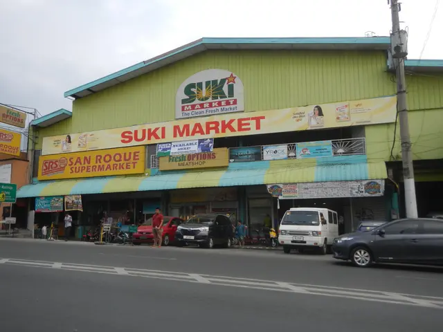 The image shows a bustling street scene with vehicles driving on the road, people walking on the...