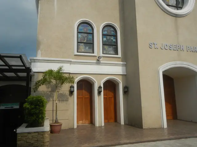 The image shows St. Joseph Parish Church, with its doors, windows, lights, and text on the...