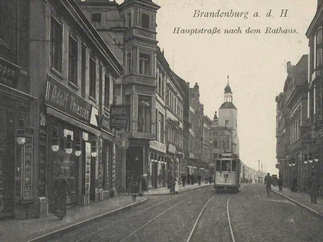 The image shows an old black and white photo of a city street in Brandenburg, Germany. We can see a...