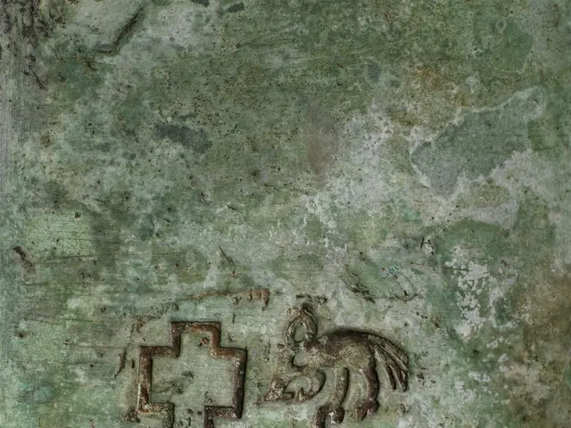 The image shows a close up of a metal object with a cross on it, which appears to be a photo of a...