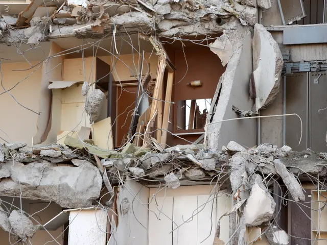The image shows a building that has been partially demolished, with broken walls and debris...