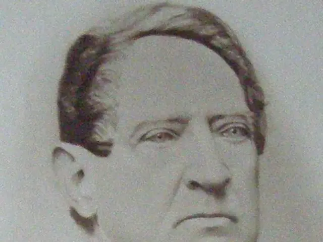 The image shows a black and white photo of a man in a priest's robes, believed to be the Archbishop...