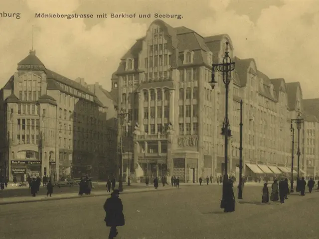 The image shows an old black and white photo of people walking down a street in Hamburg, Germany....