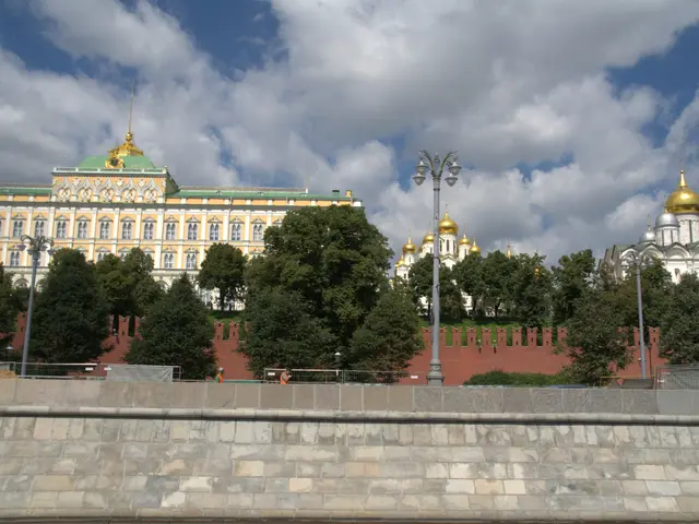 The image shows the majestic Kremlin in Moscow, Russia, with its iconic buildings, trees, street...