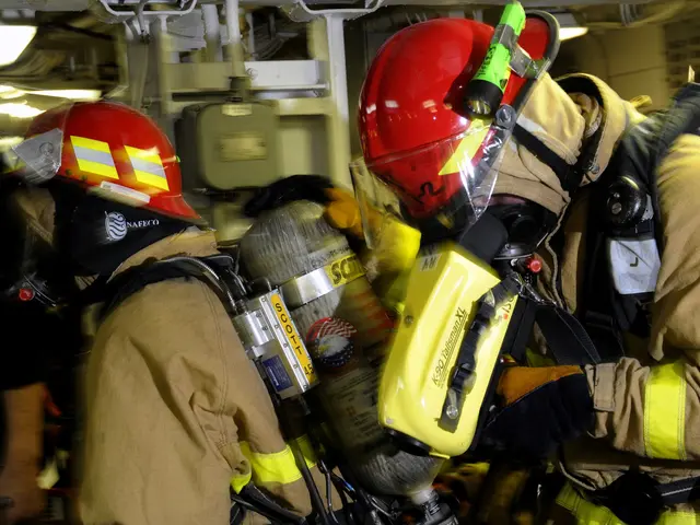 The image shows a group of firefighters wearing firefighting gear, including helmets and oxygen...