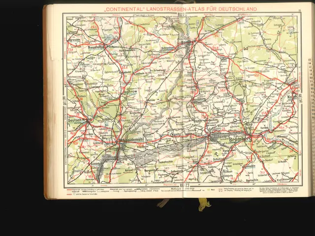 The image shows an open book with a map of Germany on it, set against a black background. The map...