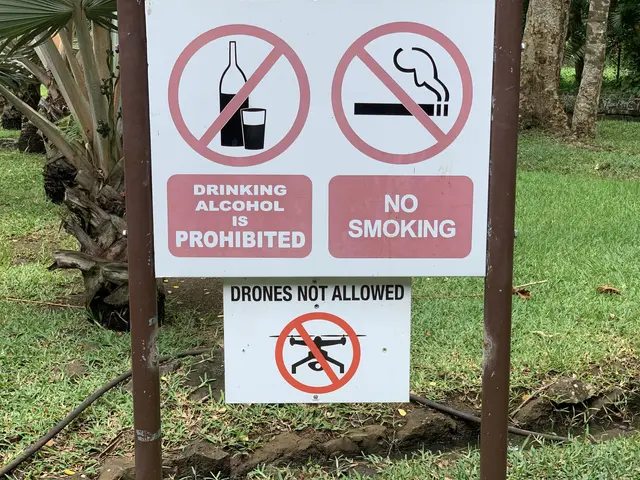 The image shows a sign on the side of a road that reads "Drinking Alcohol is Prohibited" and "No...