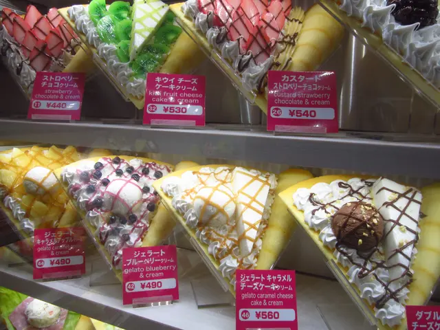 The image shows a display case filled with a variety of different types of ice cream, each with a...