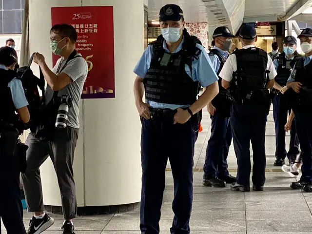 The image shows a group of police officers standing next to each other in front of a building. They...