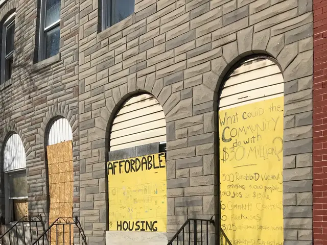 The image shows a building with boarded up windows and a sign on the side of it that reads...