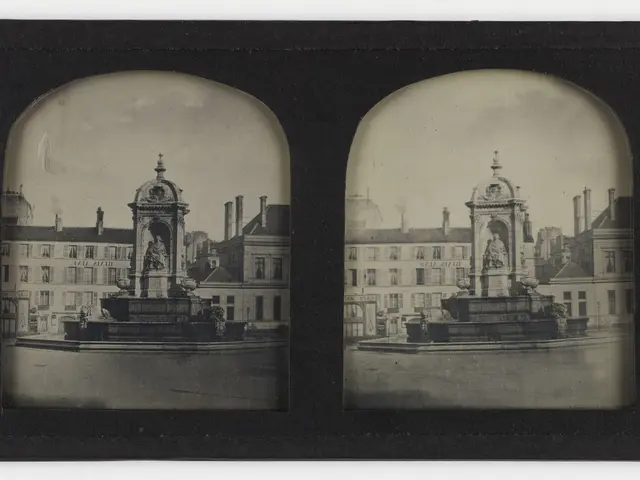 The image shows a black and white photo of a fountain in the middle of a city, surrounded by...