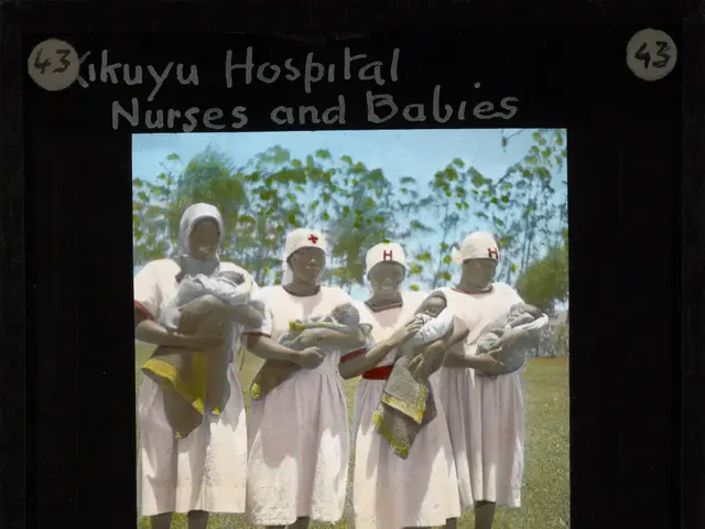 The image shows a group of women standing on the ground, each holding a baby in their hands, with...