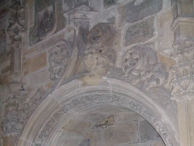 The image shows a man in a priest's robes standing in front of an archway in a church. He is...