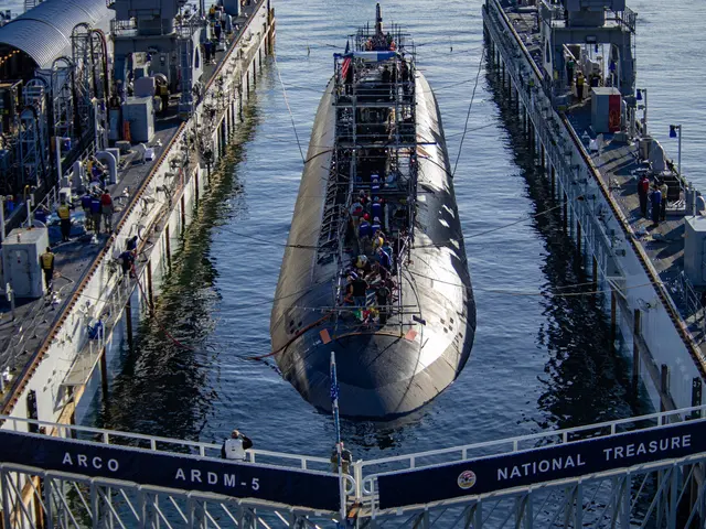 The image shows two submarines docked in the water near each other, with people standing on the...