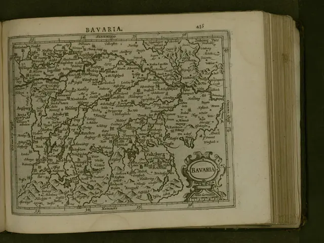 The image shows an open book with a map of Bavaria on it. The map is detailed and shows the various...