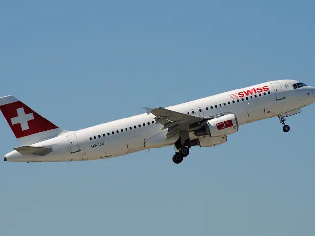 The image shows a Swiss Airlines Airbus A320-200 in flight, with its white and red livery standing...