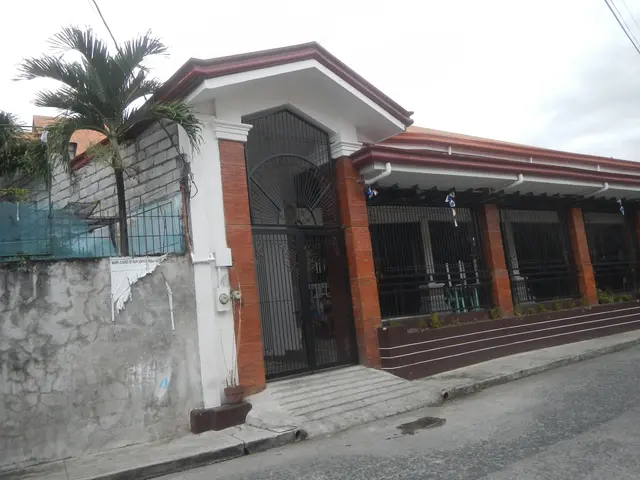 The image shows a house for sale in Imus, Cavite, Philippines. It has a roof, windows, a gate, a...