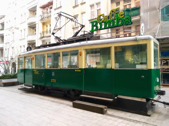 The image shows a green and yellow tram on a city street, surrounded by buildings with windows,...