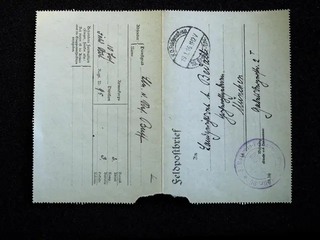 The image shows an old document with two stamps on it, set against a black background. The document...