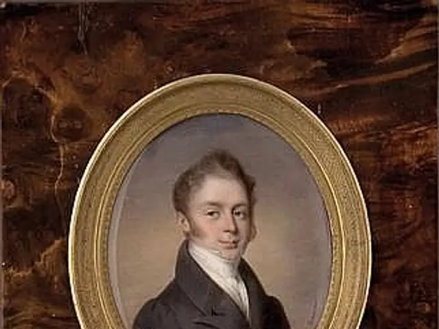 The image shows a portrait of a young man in a black coat and white shirt, framed in a photo frame...
