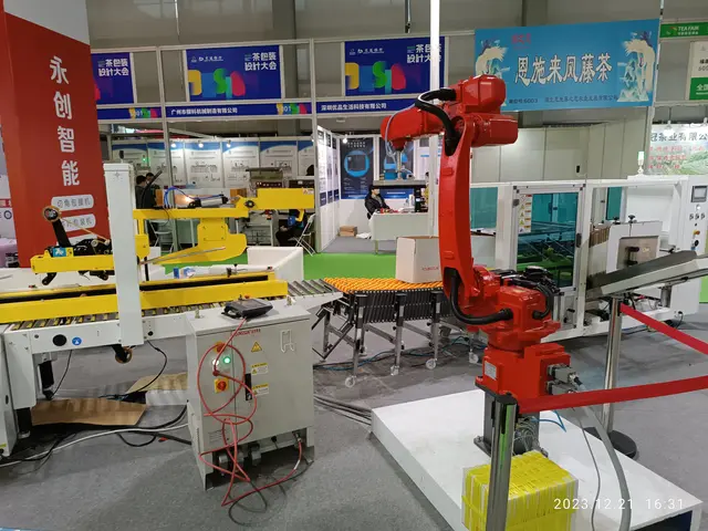 The image shows a group of robots sitting on top of a table surrounded by machines, wires, boards...