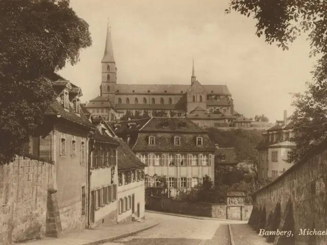 The image shows an old black and white photo of a city street with a church in the background. On...