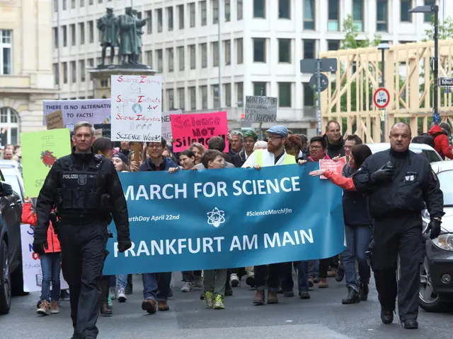 The image shows a group of people walking down a street, holding a banner that reads "March for...