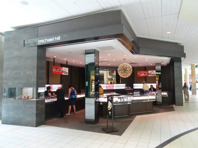 The image shows a Michael Hill jewelry store in the middle of a shopping mall. There are a few...