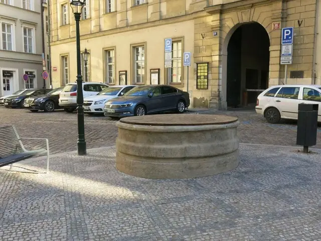 The image shows a city square with a bench sitting in the middle of it, surrounded by buildings...