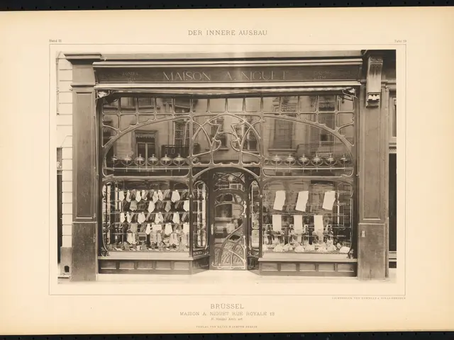 The image shows an old black and white photo of a store front with a glass door and windows. Inside...