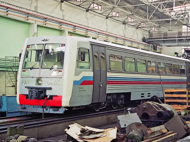 The image shows a train parked inside of a building next to a pile of junk. We can see the train on...