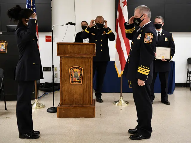 The image shows a group of people standing in front of a podium with a microphone, surrounded by...