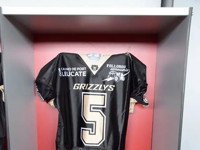 The image shows a locker with a football jersey and helmet hanging on it, along with a water bottle...