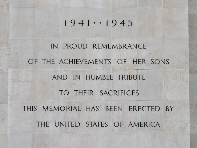 The image shows a monument with a plaque on the side of it that reads "In Proud Remembrance of the...