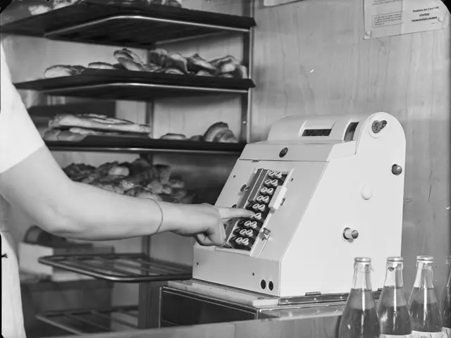 The image shows a black and white photo of a person using a cash register in a store. On the right...