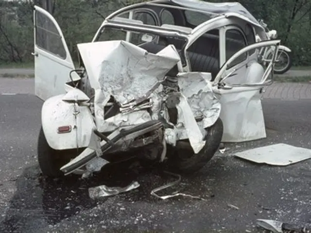 The image shows a car that has been involved in a crash on the side of the road, with its front end...